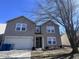 Charming two-story home with attached garage, landscaped yard, and blue trash bins at 14457 Orange Blossom Trl, Fishers, IN 46038