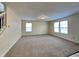Spacious living room filled with natural light from two windows, and neutral carpet at 14457 Orange Blossom Trl, Fishers, IN 46038