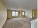 Spacious living room with carpet, fan, and two windows at 14457 Orange Blossom Trl, Fishers, IN 46038