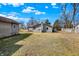 View of large backyard with detached garage and rear exterior of home at 1529 Bailey Dr, Indianapolis, IN 46241