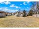 Expansive backyard with a detached garage and stone chimney; partially fenced at 1529 Bailey Dr, Indianapolis, IN 46241