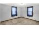 Cozy bedroom with neutral carpet, gray walls, and natural lighting at 1529 Bailey Dr, Indianapolis, IN 46241