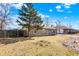 A pleasant single-story house with wood fencing and manicured lawn, set under a bright, partly cloudy sky at 1529 Bailey Dr, Indianapolis, IN 46241