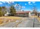 Cozy single-story home featuring a driveway leading to a detached garage in a well-kept landscape at 1529 Bailey Dr, Indianapolis, IN 46241
