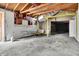 Open and unfinished garage space with exposed wood beams and a concrete floor at 1529 Bailey Dr, Indianapolis, IN 46241