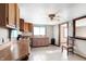 Open kitchen with tile floors, wood cabinets, natural light, and adjacent dining area at 1529 Bailey Dr, Indianapolis, IN 46241