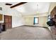 Spacious living room with beamed ceiling, carpeted floors, and natural lighting at 1529 Bailey Dr, Indianapolis, IN 46241