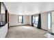 Open living room featuring neutral carpet, natural light, and access to other rooms at 1529 Bailey Dr, Indianapolis, IN 46241