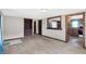 Spacious carpeted living room with built-in shelving and views into the kitchen and hallway at 1529 Bailey Dr, Indianapolis, IN 46241
