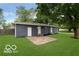 Backyard with green lawn, wooden fence, and gray exterior elevation at 1807 Dayton Ave, Indianapolis, IN 46203