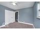 A serene bedroom features blue walls, carpet flooring, and a closet at 1807 Dayton Ave, Indianapolis, IN 46203