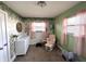 Bedroom featuring light green walls and a white dresser and rocking chair at 1807 Dayton Ave, Indianapolis, IN 46203