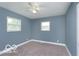 A serene bedroom features blue walls, carpet flooring, and a ceiling fan at 1807 Dayton Ave, Indianapolis, IN 46203