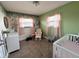 Bedroom featuring light green walls and a white crib and rocking chair at 1807 Dayton Ave, Indianapolis, IN 46203