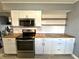 Bright kitchen featuring stainless steel appliances, with plenty of cabinet and counter space at 1807 Dayton Ave, Indianapolis, IN 46203
