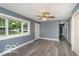 Bright living room with new floors, a ceiling fan and natural light at 1807 Dayton Ave, Indianapolis, IN 46203