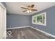 Large living room featuring new floors, a ceiling fan, and natural lighting at 1807 Dayton Ave, Indianapolis, IN 46203