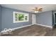 Spacious living room with new floors, bright light, ceiling fan and a fresh color palette at 1807 Dayton Ave, Indianapolis, IN 46203