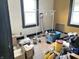 A bedroom with hardwood floors, black trim around the windows, and disorganized contents at 1826 Mansfield St, Indianapolis, IN 46202