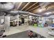 Unfinished basement with exposed ceiling and weights at 23 Greenacre Dr, Brownsburg, IN 46112