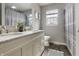 Bathroom featuring a double sink vanity, light grey walls, and shower-tub combination with stylish curtain at 23 Greenacre Dr, Brownsburg, IN 46112