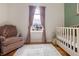 Charming Bedroom with a rocking chair, crib, hardwood floors, and ample natural light at 23 Greenacre Dr, Brownsburg, IN 46112