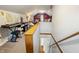 Spacious bonus room with a home office area, keyboard, daybed, and hardwood staircase at 23 Greenacre Dr, Brownsburg, IN 46112
