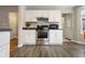 Modern kitchen featuring stainless steel appliances, white cabinetry, and ample counter space at 23 Greenacre Dr, Brownsburg, IN 46112