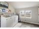 Bright laundry room with a modern washer and dryer, natural light, and practical shelving at 23 Greenacre Dr, Brownsburg, IN 46112