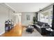 Spacious living room with hardwood floors, neutral walls, and a view into the adjacent dining area at 3515 S Meadow Dr, Indianapolis, IN 46239