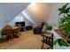 Attic space with seating area including a round table and chairs, a television, trunk and a recliner at 3615 E State Rd 32, Lebanon, IN 46052