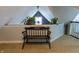 Charming attic space with an antique bench, plants and carpet flooring for a cozy retreat or additional living area at 3615 E State Rd 32, Lebanon, IN 46052