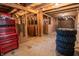 Rustic barn interior with wooden beams, stalls, and a red toolbox showcasing its utilitarian charm at 3615 E State Rd 32, Lebanon, IN 46052