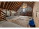 Expansive barn interior with exposed beams, plywood flooring, and natural light from a window providing ample storage or workspace at 3615 E State Rd 32, Lebanon, IN 46052