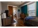 Bedroom with hardwood floors, a workstation, and a closet that opens to another room at 3615 E State Rd 32, Lebanon, IN 46052