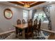 Charming dining room featuring wood table and chairs, decorative light fixture, and windows with patterned curtains at 3615 E State Rd 32, Lebanon, IN 46052