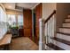 Inviting entryway with wood floors, a bench, a decorative rug, and a staircase with white railings at 3615 E State Rd 32, Lebanon, IN 46052