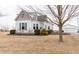 Beautiful two-story home with white siding, green roof, a lush yard, and detached garage at 3615 E State Rd 32, Lebanon, IN 46052