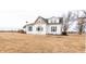 This two story home with white siding and green shutters has a sprawling yard at 3615 E State Rd 32, Lebanon, IN 46052