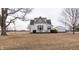 Charming two-story home with green roof and a detached garage, surrounded by an open yard at 3615 E State Rd 32, Lebanon, IN 46052