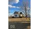 Charming two-story home featuring a bright exterior and a detached two-car garage with a long driveway at 3615 E State Rd 32, Lebanon, IN 46052