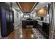 Modern kitchen featuring dark cabinetry, stainless steel appliances, and wood floors offering a blend of style and functionality at 3615 E State Rd 32, Lebanon, IN 46052