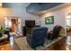 Comfortable living room with an inviting entry and view into the stairwell featuring a cozy area rug and a large flatscreen TV at 3615 E State Rd 32, Lebanon, IN 46052