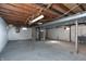 Unfinished basement with painted block walls, exposed ceiling and utilities at 3723 N Olney St, Indianapolis, IN 46218