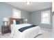 Comfortable bedroom featuring a queen-size bed, and two windows that provide ample natural light at 3723 N Olney St, Indianapolis, IN 46218