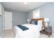 Bedroom with a queen bed, two side tables, and natural light from a window at 3723 N Olney St, Indianapolis, IN 46218