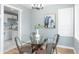 Bright dining area with a glass table, modern chairs, and an elegant light fixture at 3723 N Olney St, Indianapolis, IN 46218