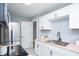 Bright kitchen features stainless steel appliances, wood countertops, white cabinets, and open doorway at 3723 N Olney St, Indianapolis, IN 46218
