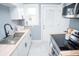 Well-lit kitchen features white cabinets, butcher block countertops, stainless steel sink, and modern appliances at 3723 N Olney St, Indianapolis, IN 46218
