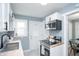 Cozy kitchen with stainless steel appliances, white cabinets, wood countertop, and adjacent dining area at 3723 N Olney St, Indianapolis, IN 46218